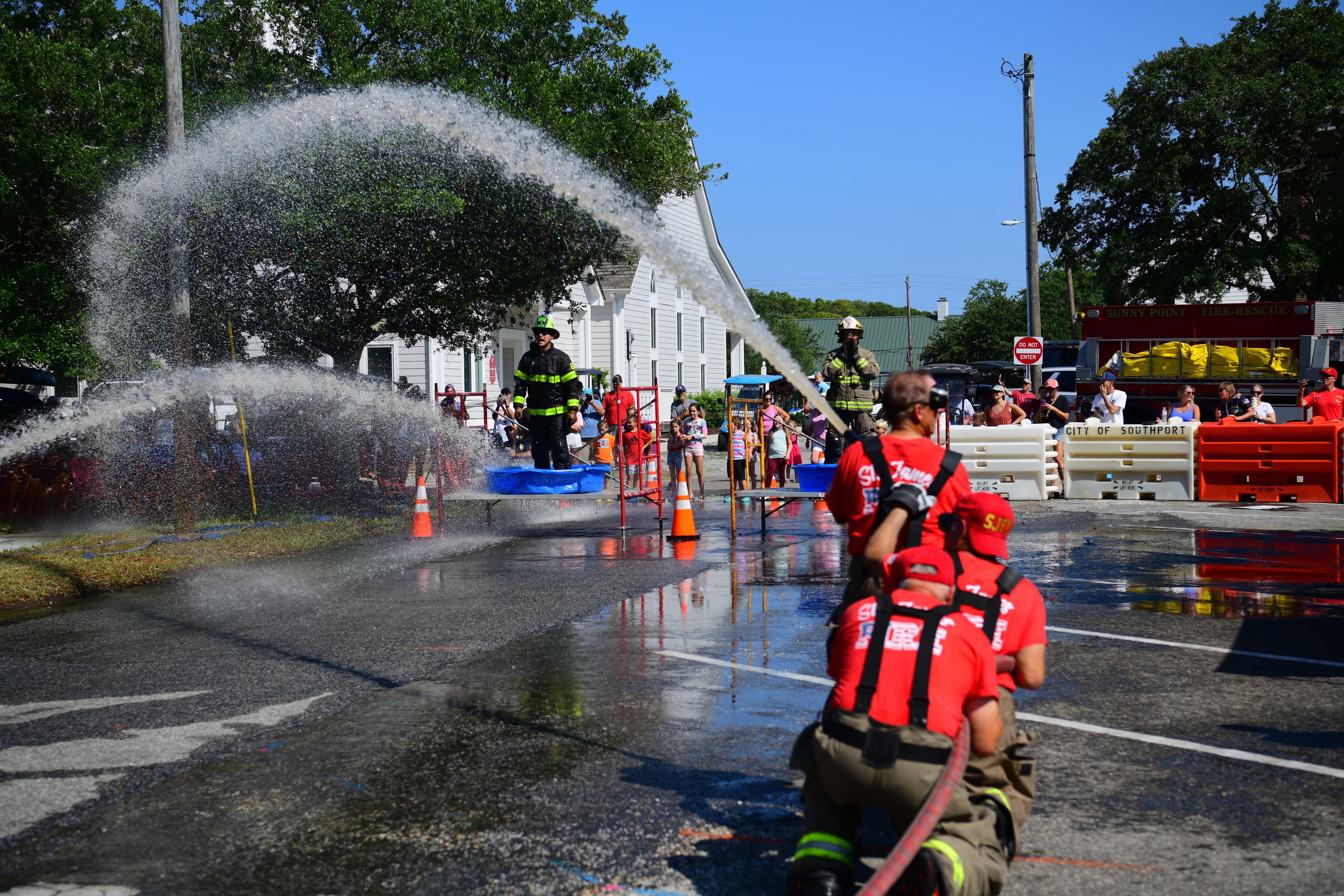 SJFD team spraying a wide arc of water during a hose challenge at the 2026 competition