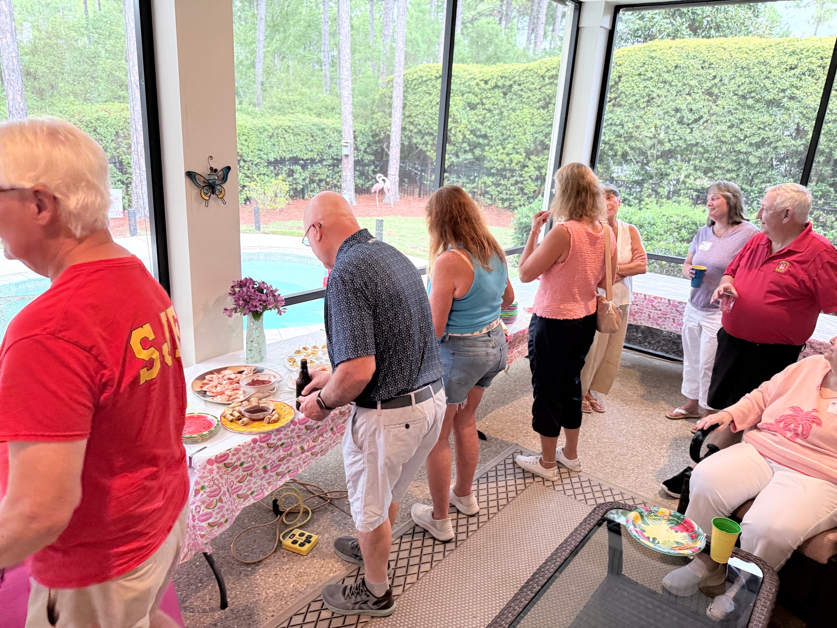 Fire Police volunteers and guests mingling in the screened pool room at the Williams home