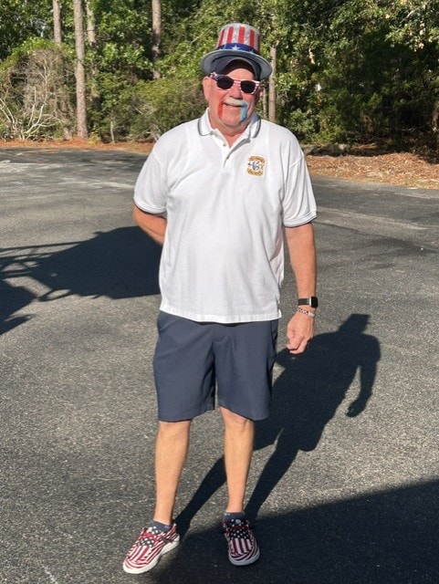 SJFD volunteer in patriotic hat and SJFD polo shirt ready for the parade