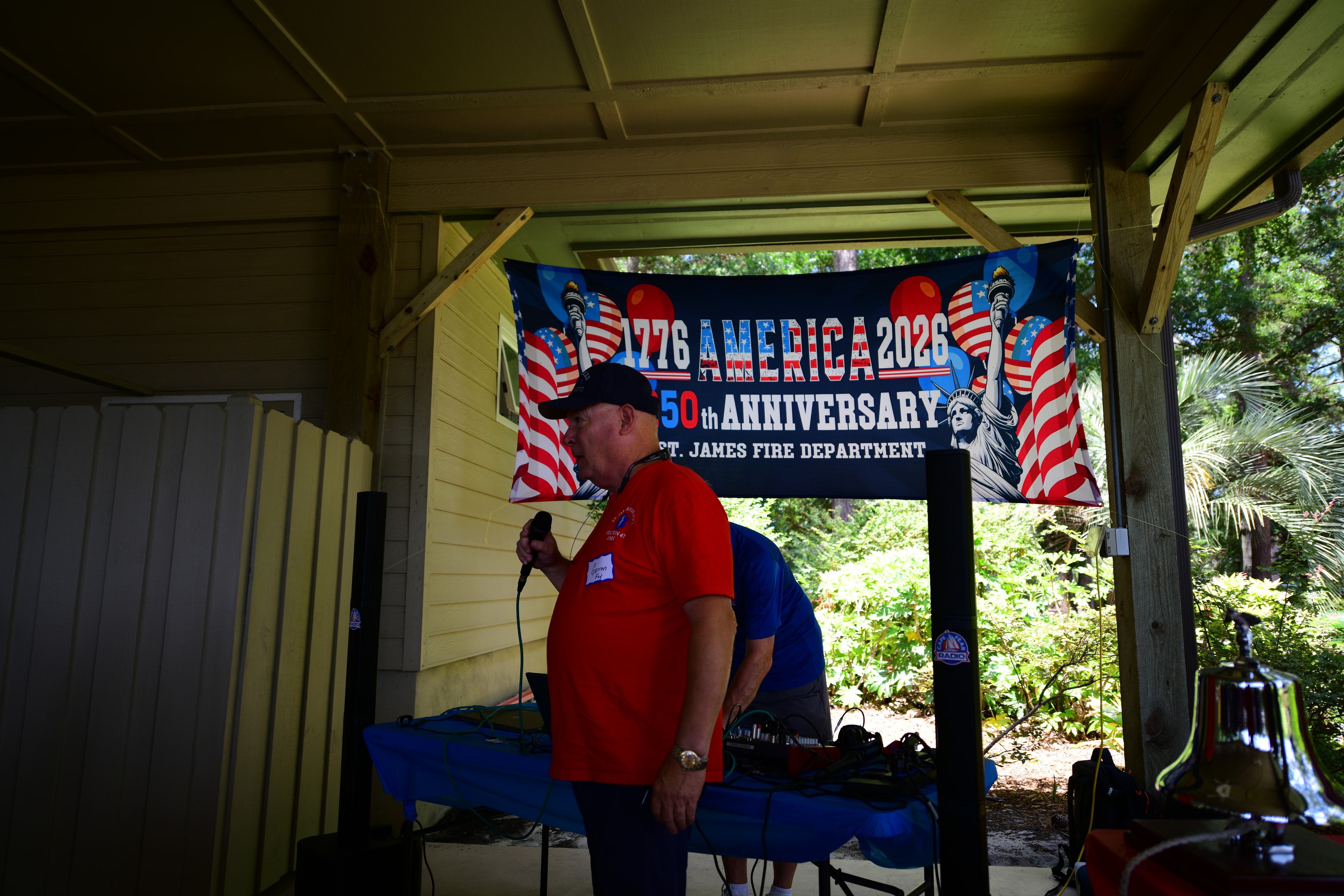 SJFD member speaks at the podium in front of the 1776 America 2026 250th Anniversary banner