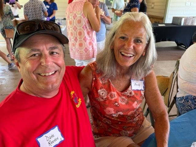 Dave Reeves in SJFD red shirt and Wendy laugh together at the picnic pavilion