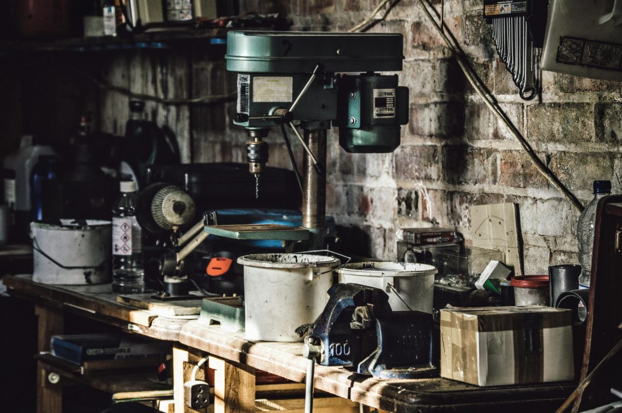Cluttered garage workshop with tools and flammable materials