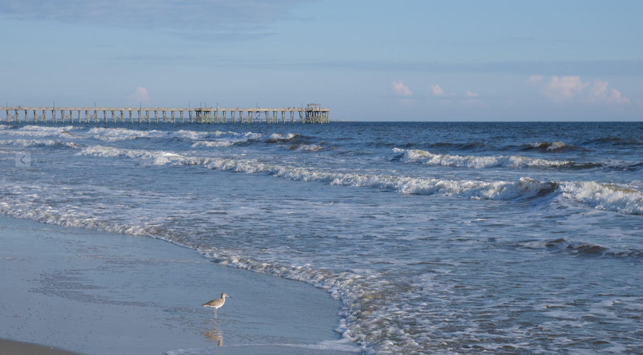 Oak Island shoreline with pier and waves